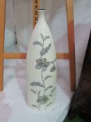 Tall cream coloured ceramic bottle/vase decorated with flowers, height 64cms. Estimate £10-20.
