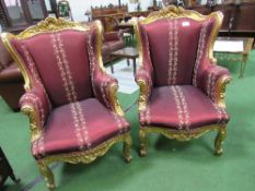 Pair of circa 1840 French Louis XVI giltwood throne wing chairs, covered in burgundy damask silk.