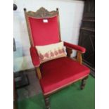 Oak framed upholstered open armchair on castors.