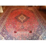 Red ground wool carpet, 4.5m x 3m. Estimate 100-200.