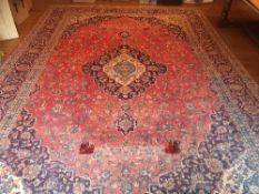 Red ground wool carpet, 4.5m x 3m. Estimate 100-200.