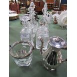 6 various cut glass decanters, glass ice bucket c/w tongs & silver plated lidded jug. Estimate £20-