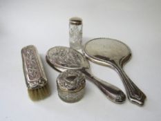 Hallmarked silver backed dressing table mirror, another with matching clothes' brush, silver handled