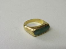 18ct gold ring set with large oblong green stone approx 18mm x 6mm, size R 1/2, total wt 8.0gms.