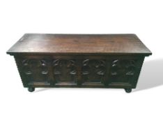 Oak blanket box with carved front standing on bun feet, 107cms x 44cms x 39cms. Estimate £30-50.