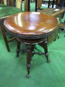 Wind-out seat piano stool on 4 ornately carved legs to ball & claw feet. Estimate £50-70.