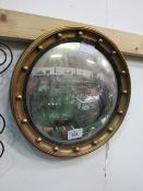 Circular gilt famed wall mirror. Estimate £5-10.