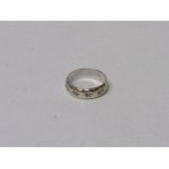 9ct white gold band with star decorations, size K 1/2, wt 2.6gms. Estimate £20-30.