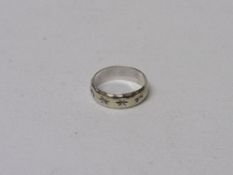 9ct white gold band with star decorations, size K 1/2, wt 2.6gms. Estimate £20-30.