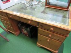 Pine pedestal desk with green leather skiver, on castors, 154cms x 76cms x 76cms. Estimate £50-70.