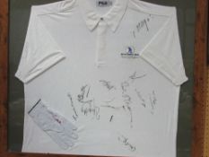 A framed & glazed golfing glove & shirt, shirt signed by various players including Colin Montgomery,