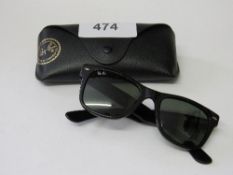 Original Ray Ban sunglasses in leather case. Estimate £30-40.