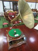 Rare early HMV wind-up large brass horn mounted record player. Estimate £30-50.