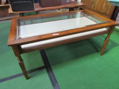 Glass top low collector's display cabinet with sliding tray. Estimate £80-100.