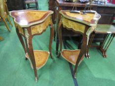 A pair of burr wood serpentine edged, ormolu mounted 3 legged display tables. Estimate £40-80.