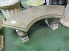Concrete curved garden seat with 2 carved supports, 107cms x 36cms x 43cms. Estimate £20-30.