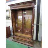 French oak glazed bookcase with drawer to base on bun feet, 126cms x 55cms x 220cms. Estimate £50-