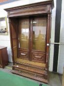 French oak glazed bookcase with drawer to base on bun feet, 126cms x 55cms x 220cms. Estimate £50-