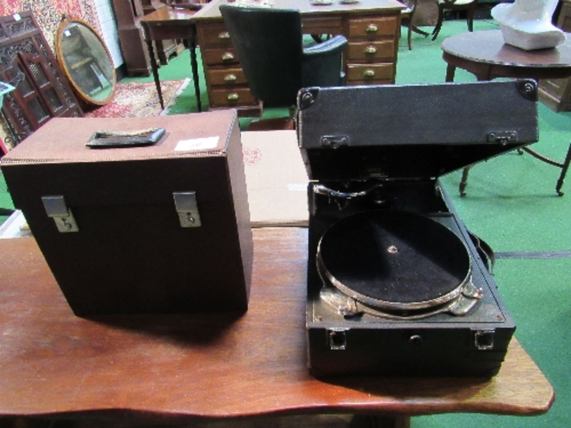 Decca wind-up gramophone c/w handle, plus a case containing some 78rpm records. Estimate £50-80.