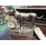 Clock in the form of a dog carrying a basket on ornate stand. Estimate £15-25.