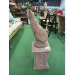 Red coloured stone-effect cat figurine in contemporary style on square red coloured concrete plinth,