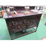 Oak sideboard cupboard with 2 drawers, front is heavily carved, 122cms x 46cms x 100cms. Estimate £