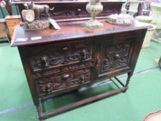 Oak sideboard cupboard with 2 drawers, front is heavily carved, 122cms x 46cms x 100cms. Estimate £