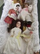 A doll's cradle together with 3 small bisque dolls, 2 by Hermann Steiner & 1 French. Estimate £50-