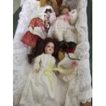 A doll's cradle together with 3 small bisque dolls, 2 by Hermann Steiner & 1 French. Estimate £50-