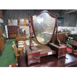 Mahogany framed shield shaped toilet mirror on base with drawers either side. Estimate £40-60.