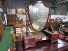 Mahogany framed shield shaped toilet mirror on base with drawers either side. Estimate £40-60.