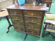 Oak chest of 2 over 3 graduated drawers with geometric designs to drawer fronts, on bun feet