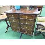 Oak chest of 2 over 3 graduated drawers with geometric designs to drawer fronts, on bun feet