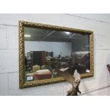 Gilt foliage framed wall mirror, 118cms x 78cms. Estimate £30-50.