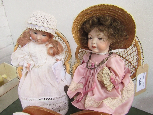 A Neubach German doll (needs re-stringing) & another doll, letter W on neck, both on small wicker