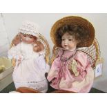A Neubach German doll (needs re-stringing) & another doll, letter W on neck, both on small wicker