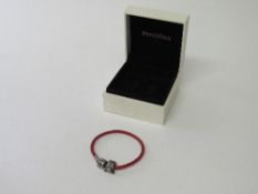 Original Pandora leather twist bracelet with moulded figure & clasp. Estimate £15-20.