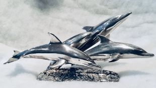 Sterling silver sculpture of dolphins leaping. A remarkable sculpture designed by M King & cast by