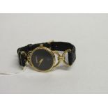 18ct gold lady's Gucci wristwatch with black leather strap. Estimate £200-250.