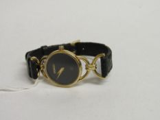 18ct gold lady's Gucci wristwatch with black leather strap. Estimate £200-250.