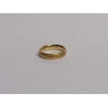 9ct gold engine turned wedding band, size R 1/2, weight 1.2gms. Estimate £90-110.
