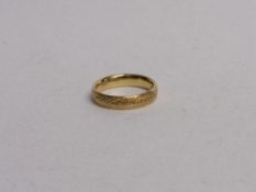 9ct gold engine turned wedding band, size R 1/2, weight 1.2gms. Estimate £90-110.