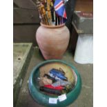 Large terracotta garden pot containing qty of sticks & umbrellas & a green glazed garden pot.
