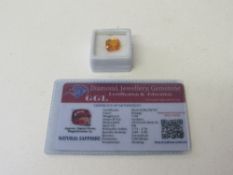 Cushion cut natural orange sapphire, weight 7.9ct, with certificate. Estimate £50-70.