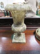 Onyx urn on a stand. Estimate £15-20.