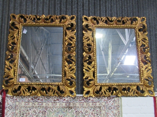A pair of highly ornate carved foliage wall mirrors (mirror size 73cms x 52cms). Estimate £120-150.