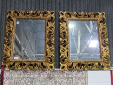 A pair of highly ornate carved foliage wall mirrors (mirror size 73cms x 52cms). Estimate £120-150.