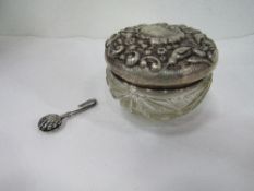 Hallmarked silver napkin holder & a hallmarked silver lidded repousse decorated glass pot.