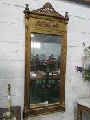 Large gilt framed wall mirror with reeded pillar sides & finials & open work crest, 74cms x