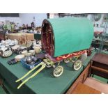 Miniature bow-top gypsy wagon, height 64cms, width 43cms & length 98cms. Estimate £100-150.